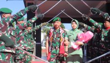Letkol Inf Raden Herman Sasmita bersama Ketua Persit Kartika Chandra Kirana Cabang XXII Kodim 0106/Aceh Tengah, Ny. Gustin Raden Herman Sasmita, melintasi gerbang kehormatan Pedang Pora saat prosesi pelepasan di Makodim 0106/Aceh Tengah, diiringi penghormatan prajurit, Kamis (23/7/2026).(Dok:Ist)